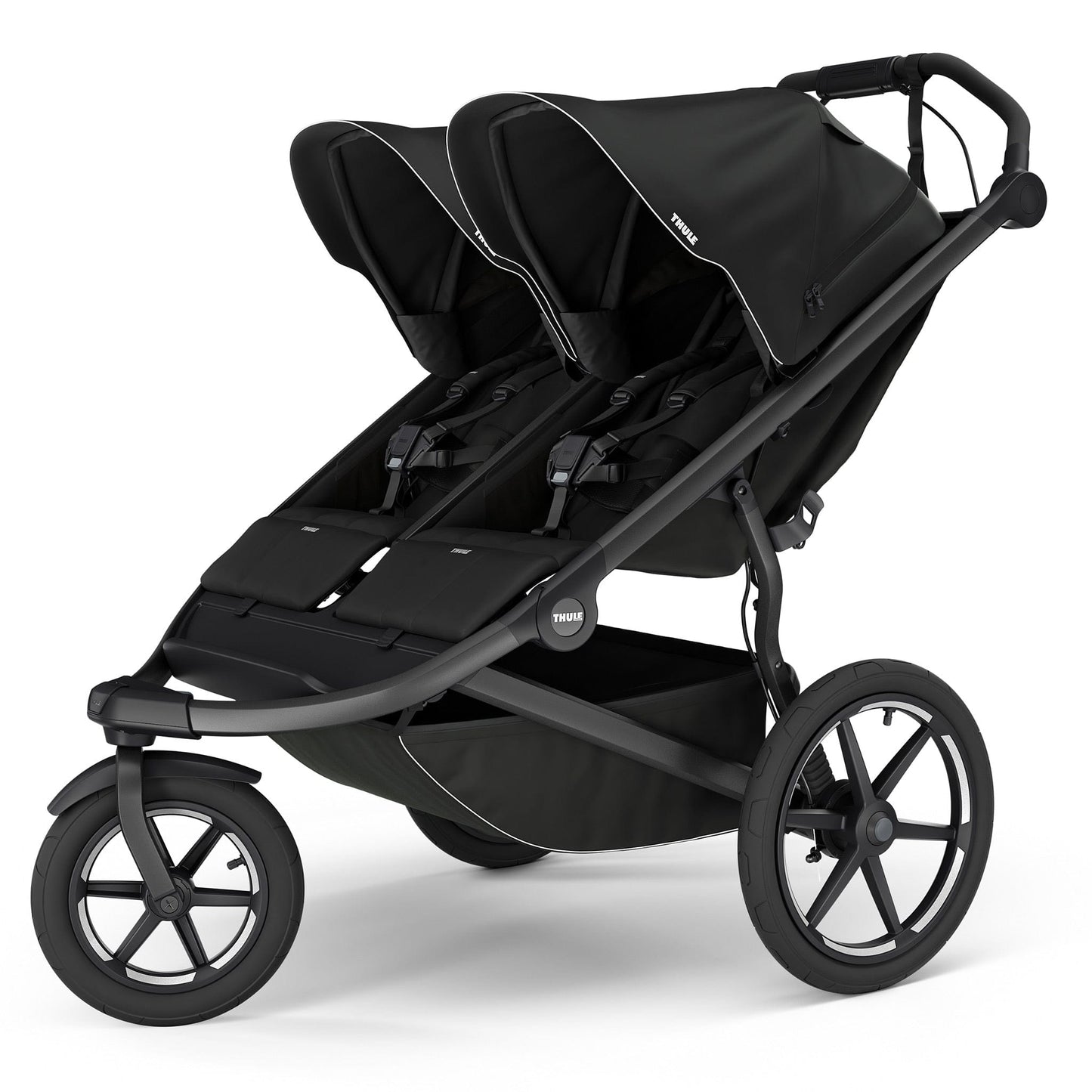 Black double jogging stroller by Thule with magnetic buckle, side view, large all-terrain wheels, padded seats, and white trim accents