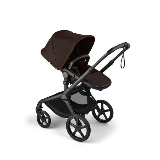 Black and cocoa brown Fox 5 Renew complete stroller by Bugaboo, featuring a matching carrycot, sleek frame, and large wheels, shown in side view.