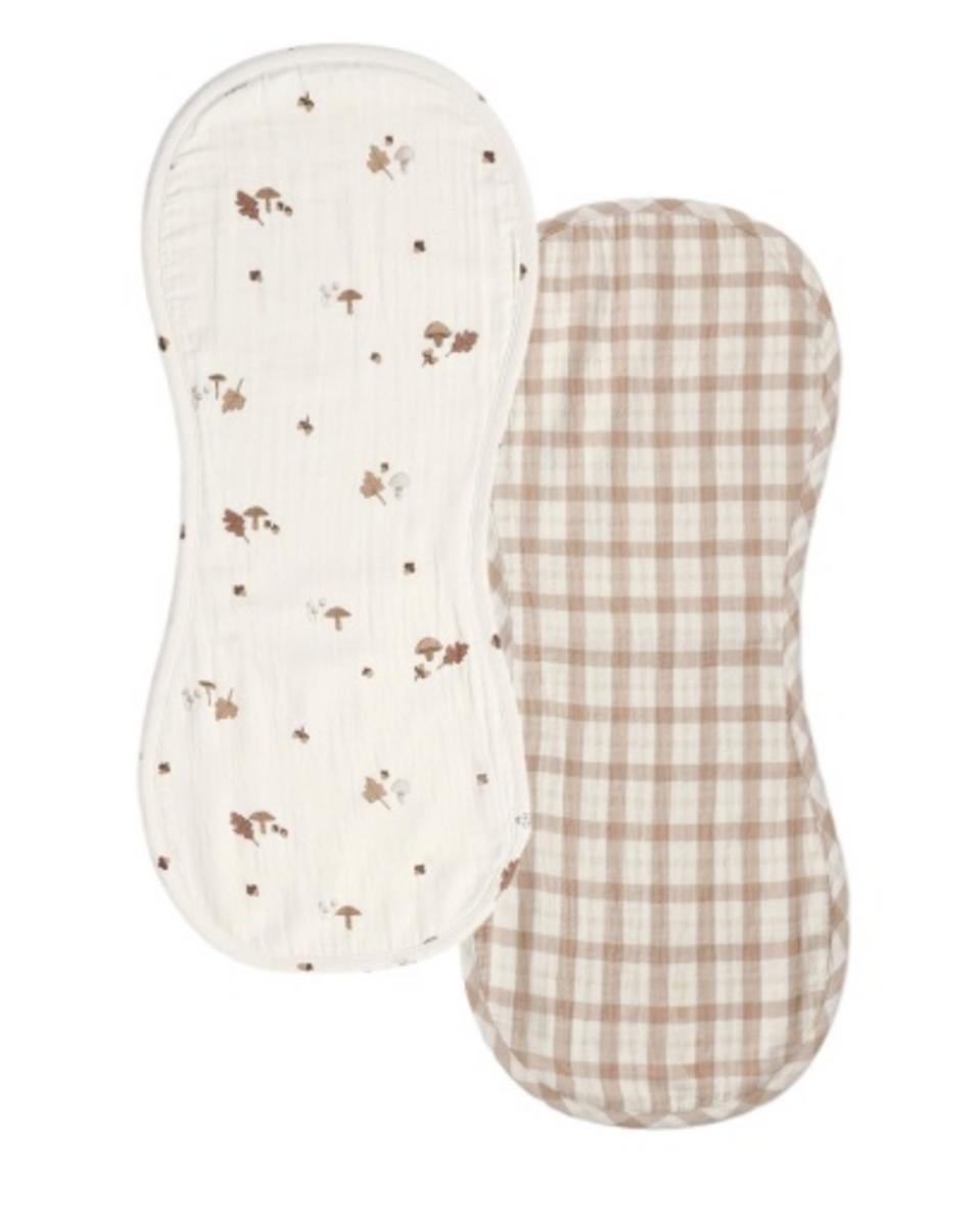 Two contoured muslin burp cloths one with mushroom print and one with beige gingham check