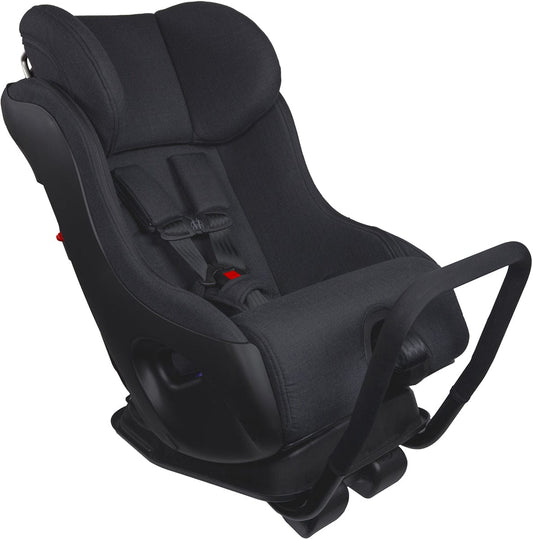 Black narrow convertible car seat by Clek, Mammoth Ziip model, with textured fabric, red buckle accents, and anti-rebound bar, side view.