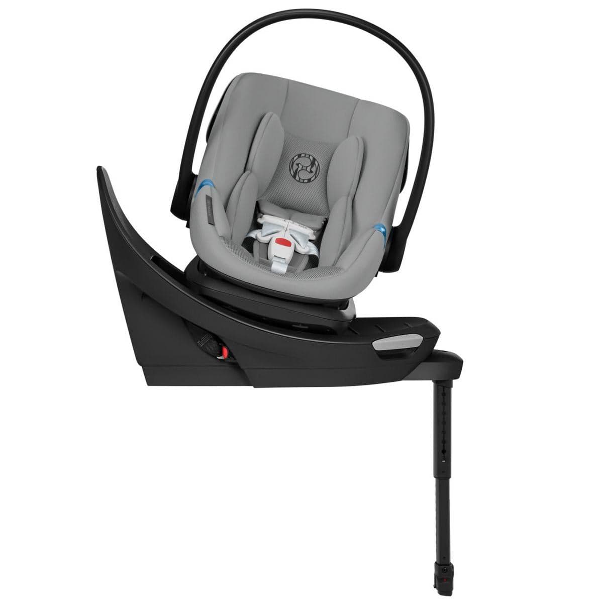 Stone grey infant car seat with black base and load leg by Cybex, featuring swivel design and padded headrest, side view