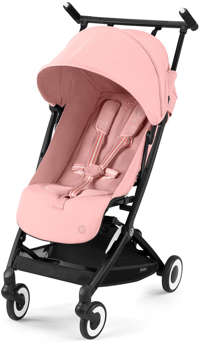 Candy pink compact stroller by Cybex with black frame, white-rimmed wheels, and striped harness straps, front view