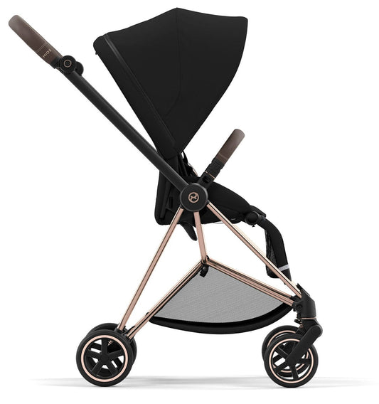 Rose gold and black Mios 3 stroller by Cybex, featuring brown leatherette accents, mesh footrest, and five-point harness, front three-quarter view