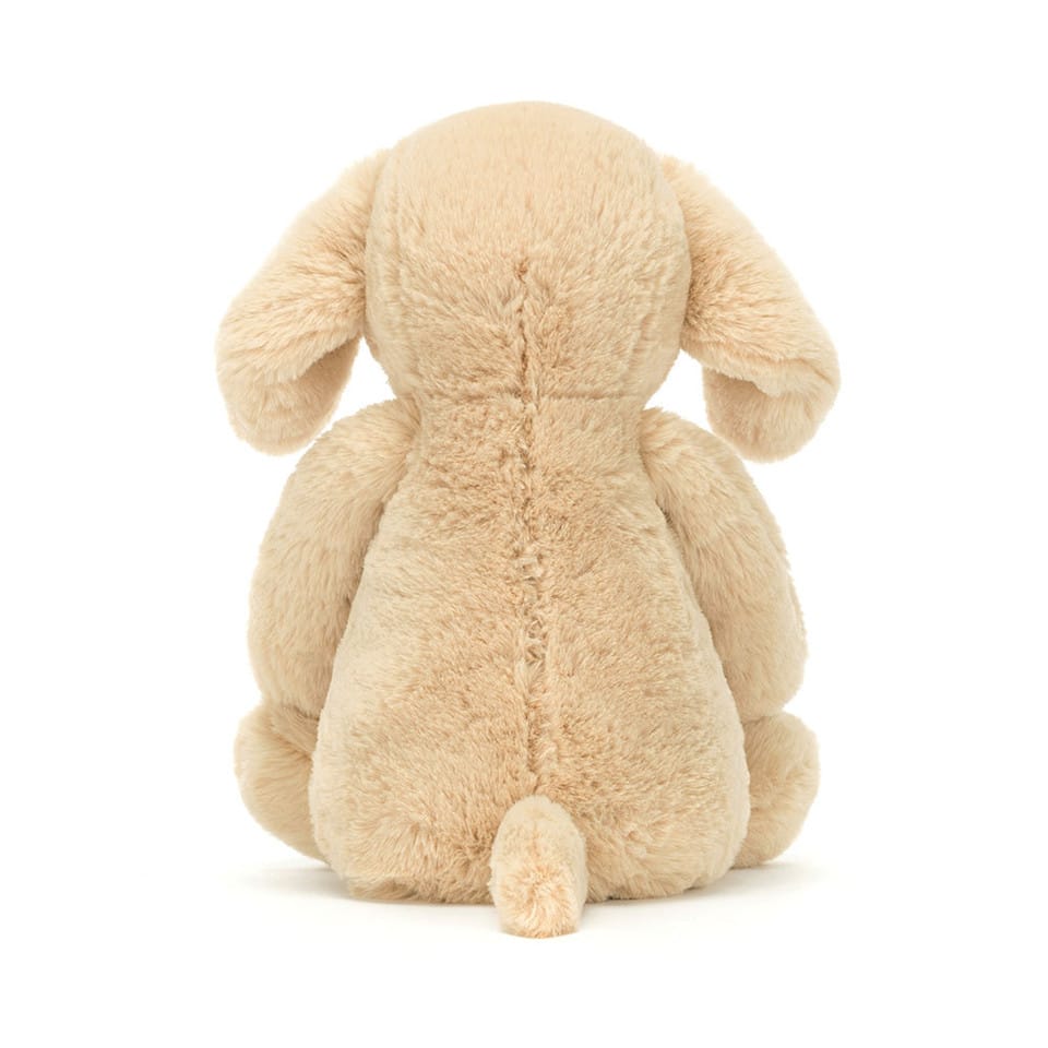 Back view of a beige Jellycat plush dog toy with floppy ears and a small tail