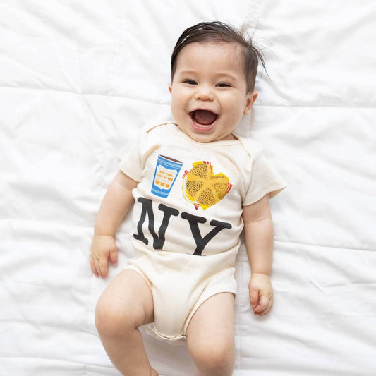 Cream colored baby bodysuit with NY text and coffee and bagel graphic