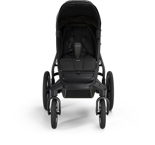 Soft beige all-terrain stroller by Thule with black frame, large wheels, and extended canopy, side view