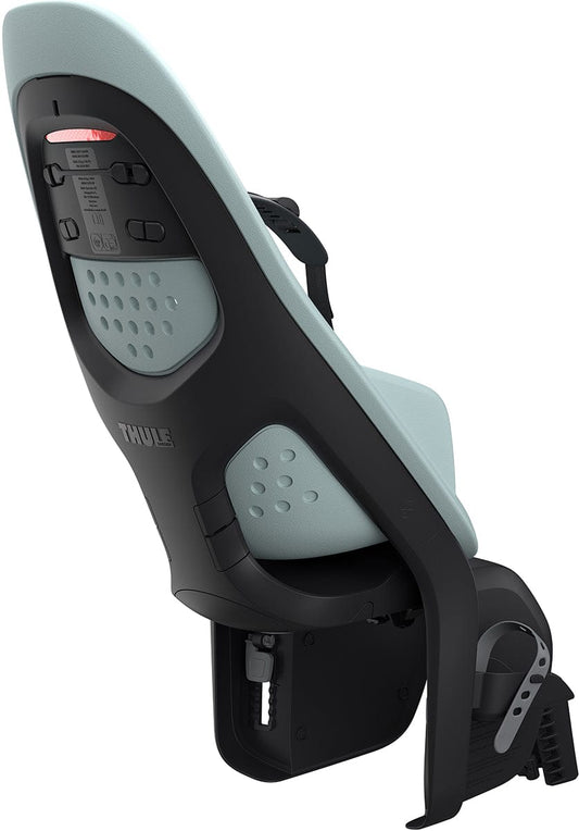 Light blue and black frame-mounted child bike seat by Thule, featuring perforated backrest, adjustable harness, and metal mounting arms, side view.