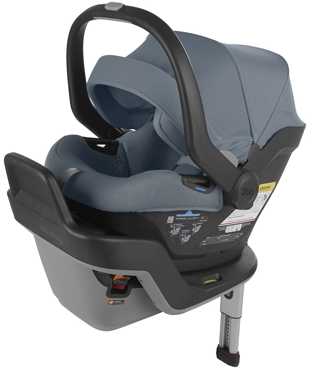 Blue melange infant car seat with load leg and anti-rebound bar by UPPAbaby, featuring merino wool fabric and black frame, side view.