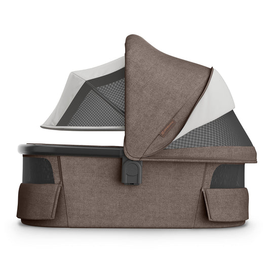 Mocha Melange fabric bassinet with carbon frame by UPPAbaby, V3 model, textured weave, side view, open canopy with mesh panel