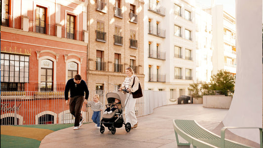 A young family strolls the city with the Silver Cross Breez stroller, enjoying a sun-kissed moment of urban exploration.