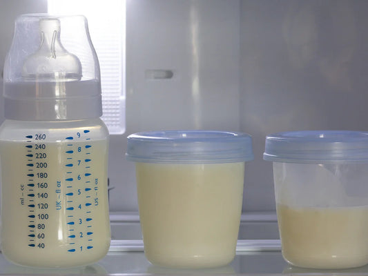 Three containers of breast milk sit on a refrigerator shelf, ready to nourish baby with love and care.
