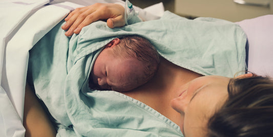 A tender moment between mother and newborn baby, skin-to-skin after delivery, conveying love and connection.
