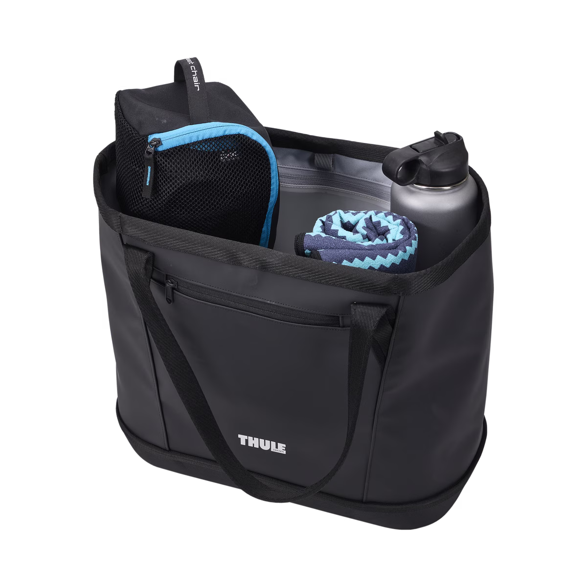Black Thule Chasm Gear Tote 30L with mesh pocket, water bottle, and towel, side view, outdoor gear storage bag