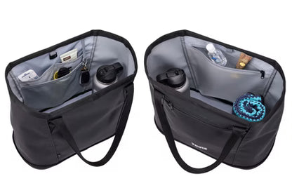 Black Thule Chasm Gear Tote 30L by Thule, open view showing interior compartments with water bottles and gear, durable fabric, side angle shot