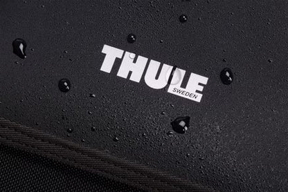Black Thule Chasm Gear Tote 30L by Thule, water-resistant textured fabric with white logo, close-up view showing droplets on surface