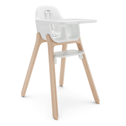 UPPAbaby white high chair with light wood legs and a tray