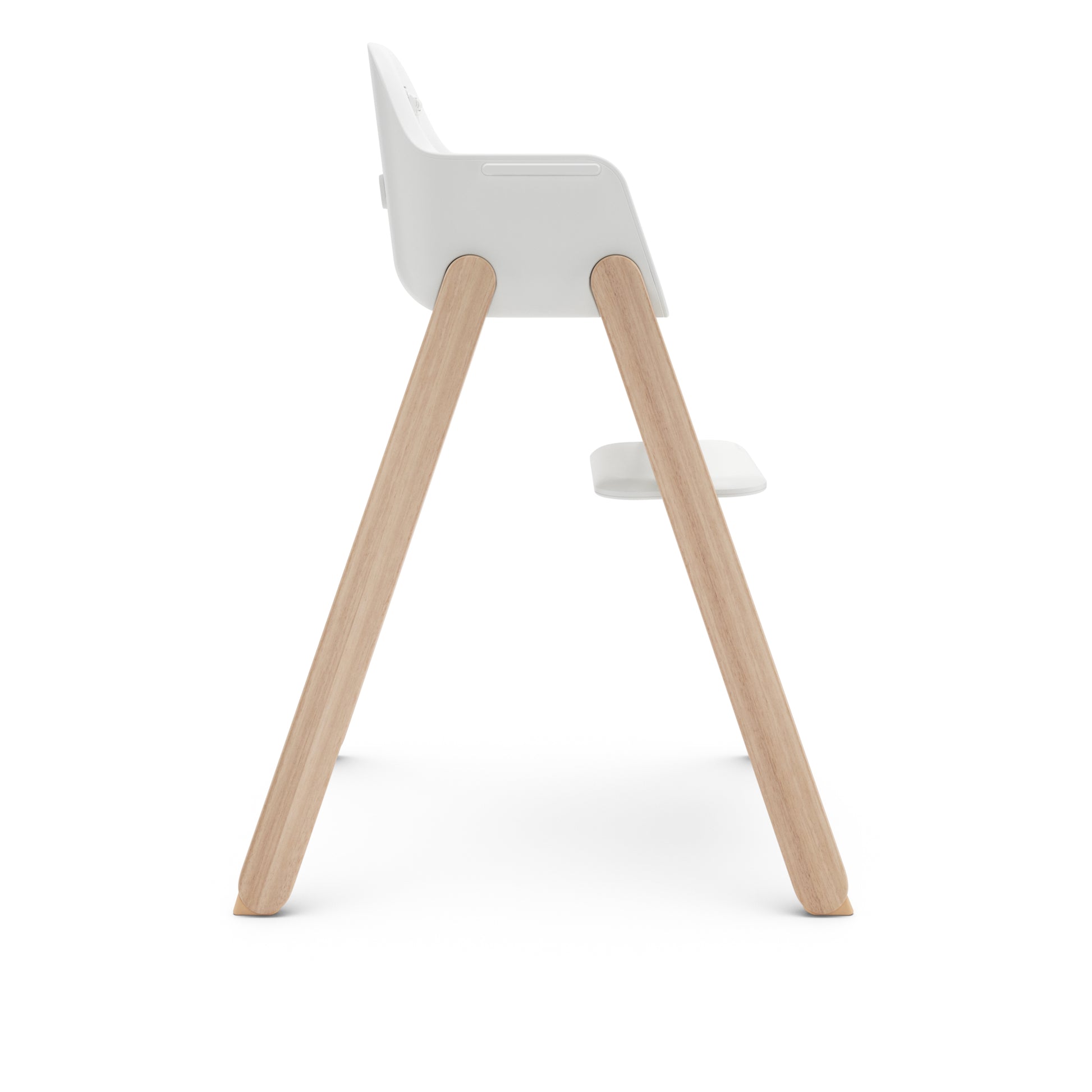 Side view of a white high chair with light wood legs and a footrest