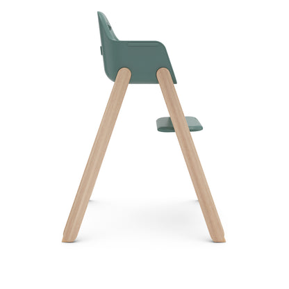 Side view of UPPAbaby high chair with green seat and wooden legs