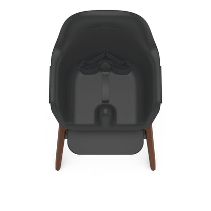 Uppababy high chair with black seat and wooden legs viewed from above