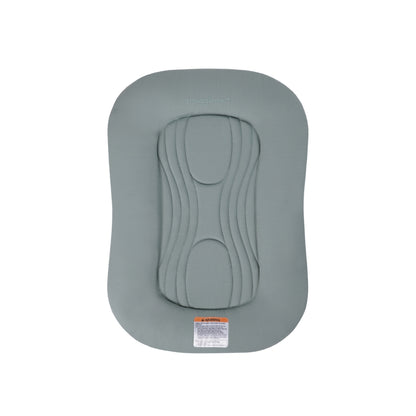 Sage green Snuggle Me infant lounger with central quilted pad and safety warning label