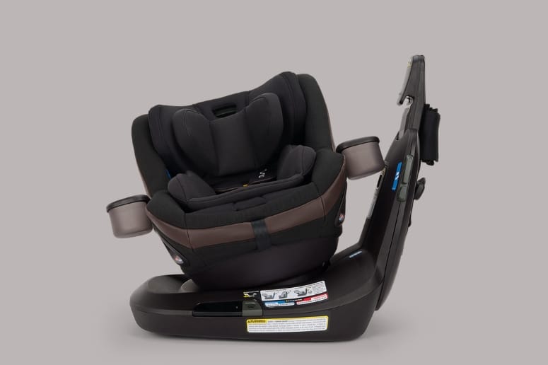 Black and brown convertible car seat with adjustable headrest, side impact protection, and safety labels on base.