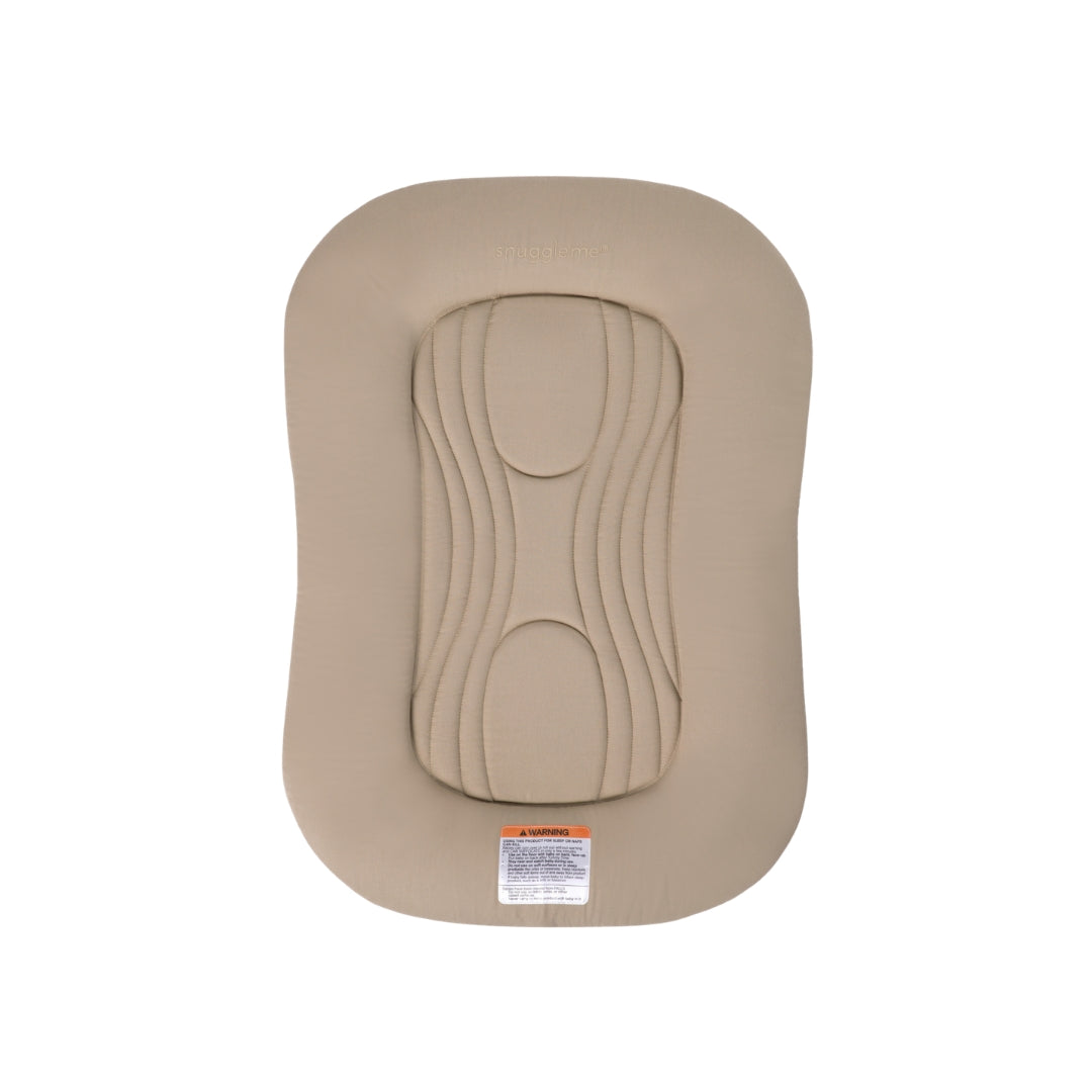 Snuggle Me infant lounger in beige with central quilted padding and safety warning label