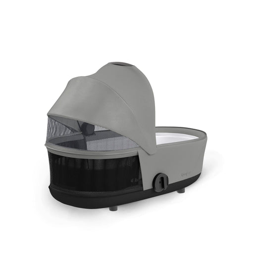Mirage Grey infant cot by Cybex with soft fabric canopy, side view, black base, and zipped storage compartment