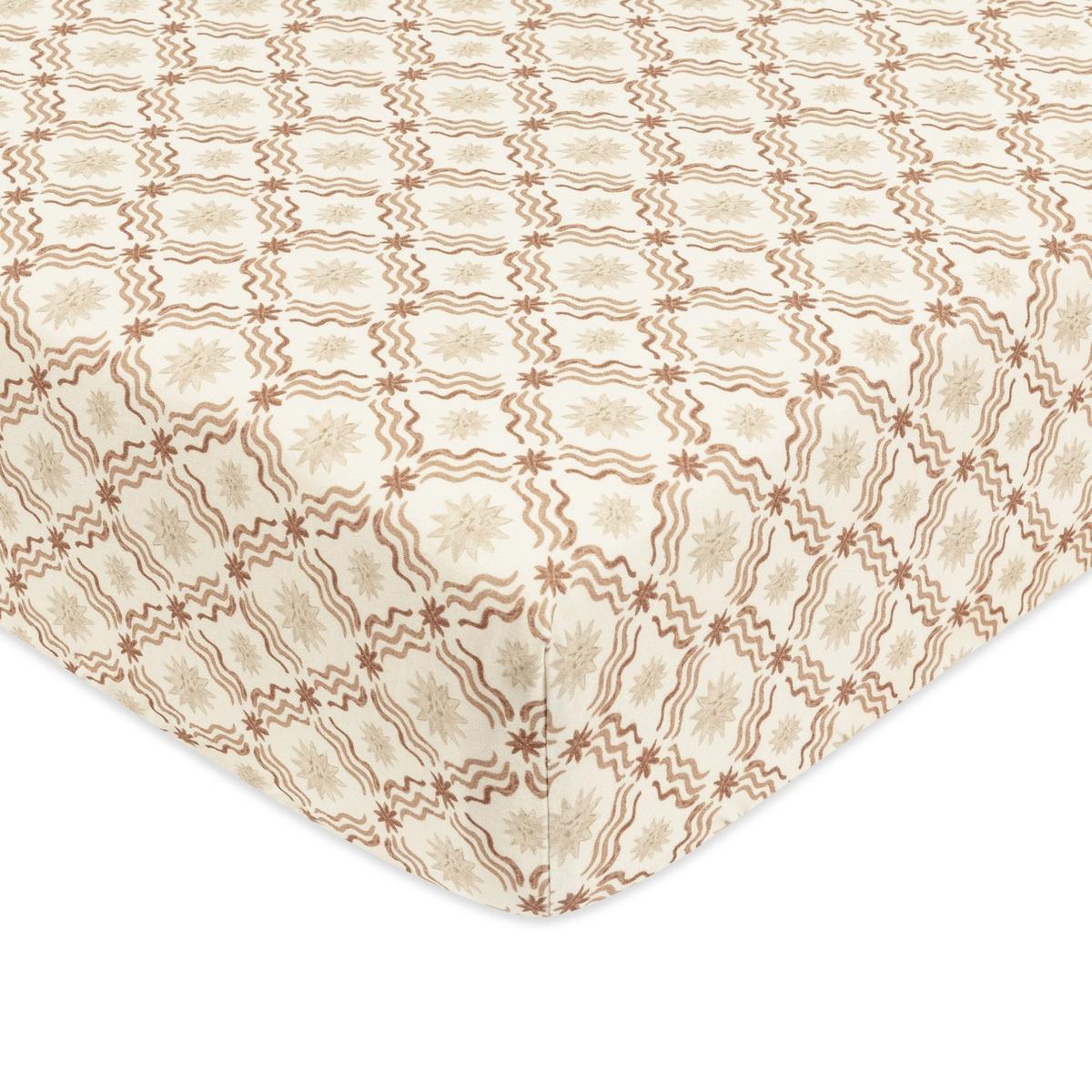 Babyletto crib sheet with brown wavy lines and star patterns on cream fabric