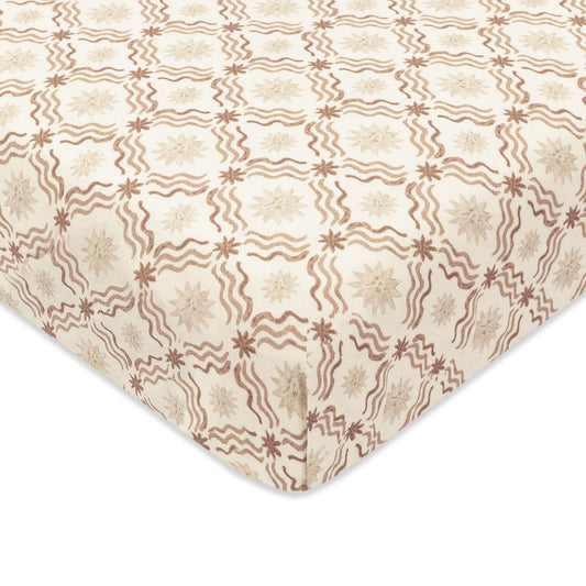 Babyletto crib sheet with brown wavy lines and star pattern on cream fabric