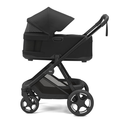 Thule black bassinet stroller in side profile view