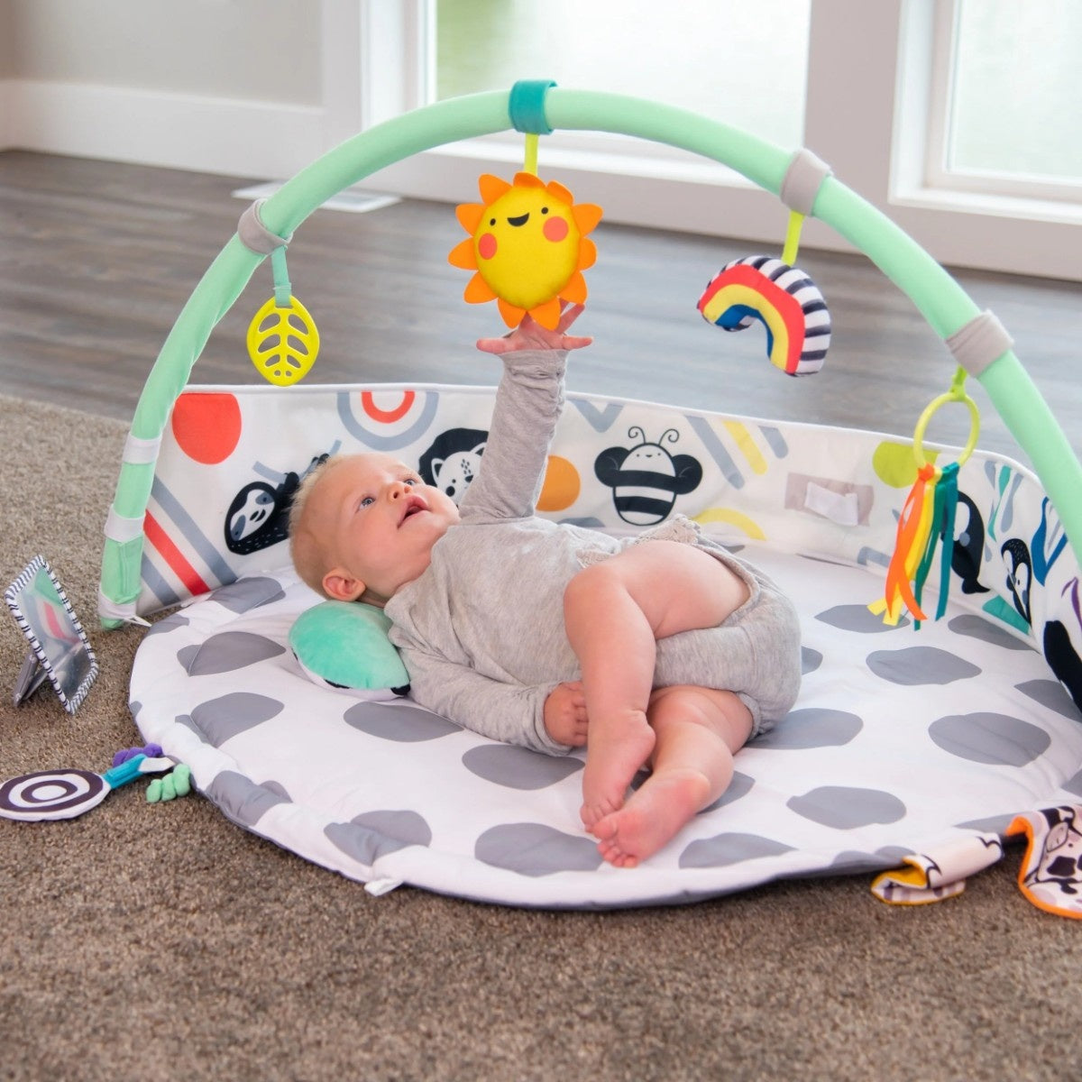 Baby reaching for toy on Sassy 3-in-1 Sensory Milestone Play Gym