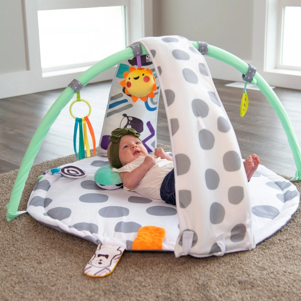 Baby lying under arches of Sassy 3-in-1 Sensory Milestone Play Gym