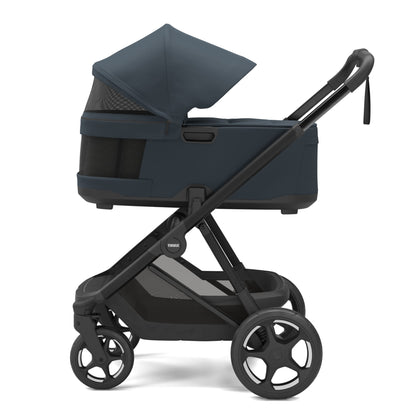 Thule Urban Glide 3 bassinet in navy blue on a black stroller frame