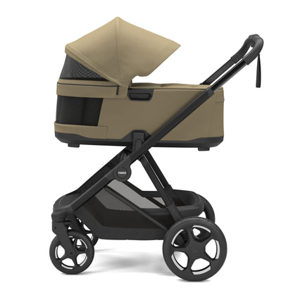 Thule beige pet stroller with black frame and mesh ventilation panels