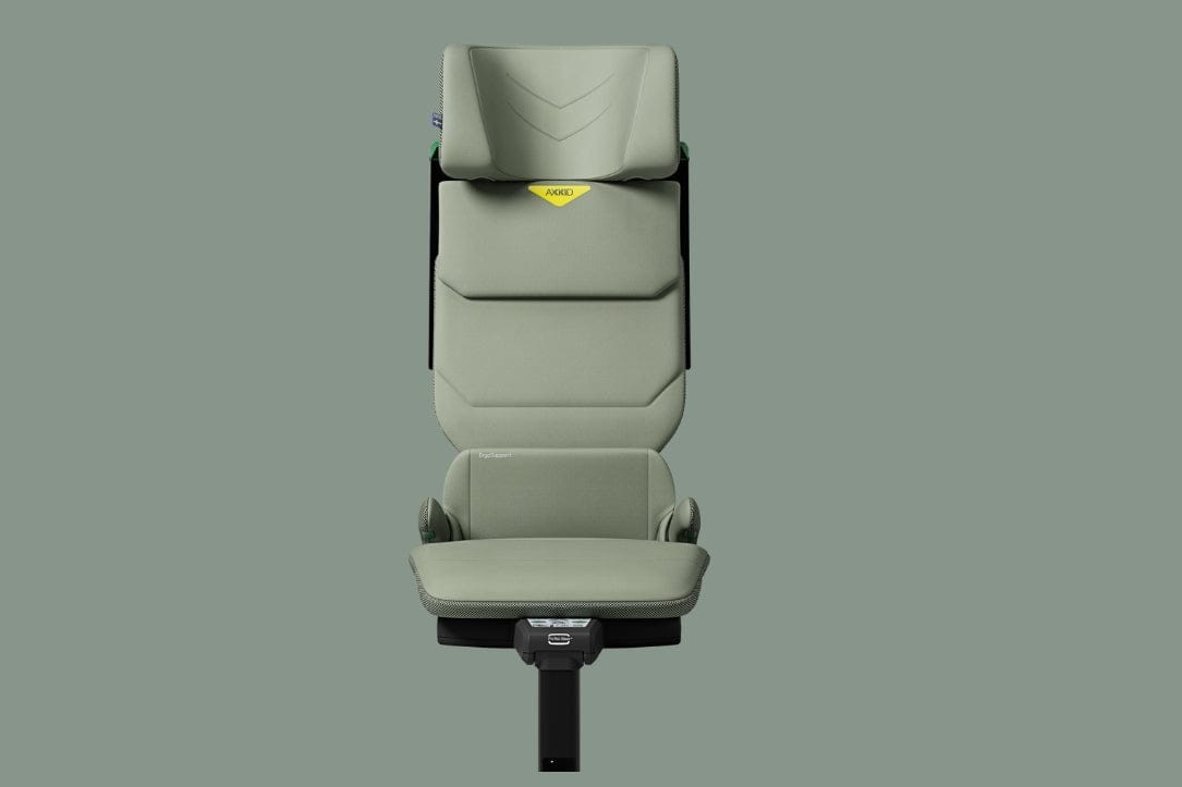 Light green child car seat with black base and yellow AXKD label, shown front-facing on solid gray background.