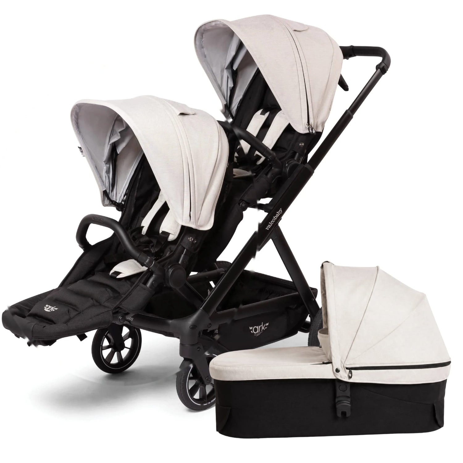 Valco Baby double stroller with two beige canopies and a matching bassinet