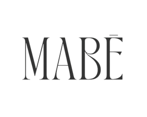 Elegant serif text "MABĒ" in dark gray on white background, with accent over final E.