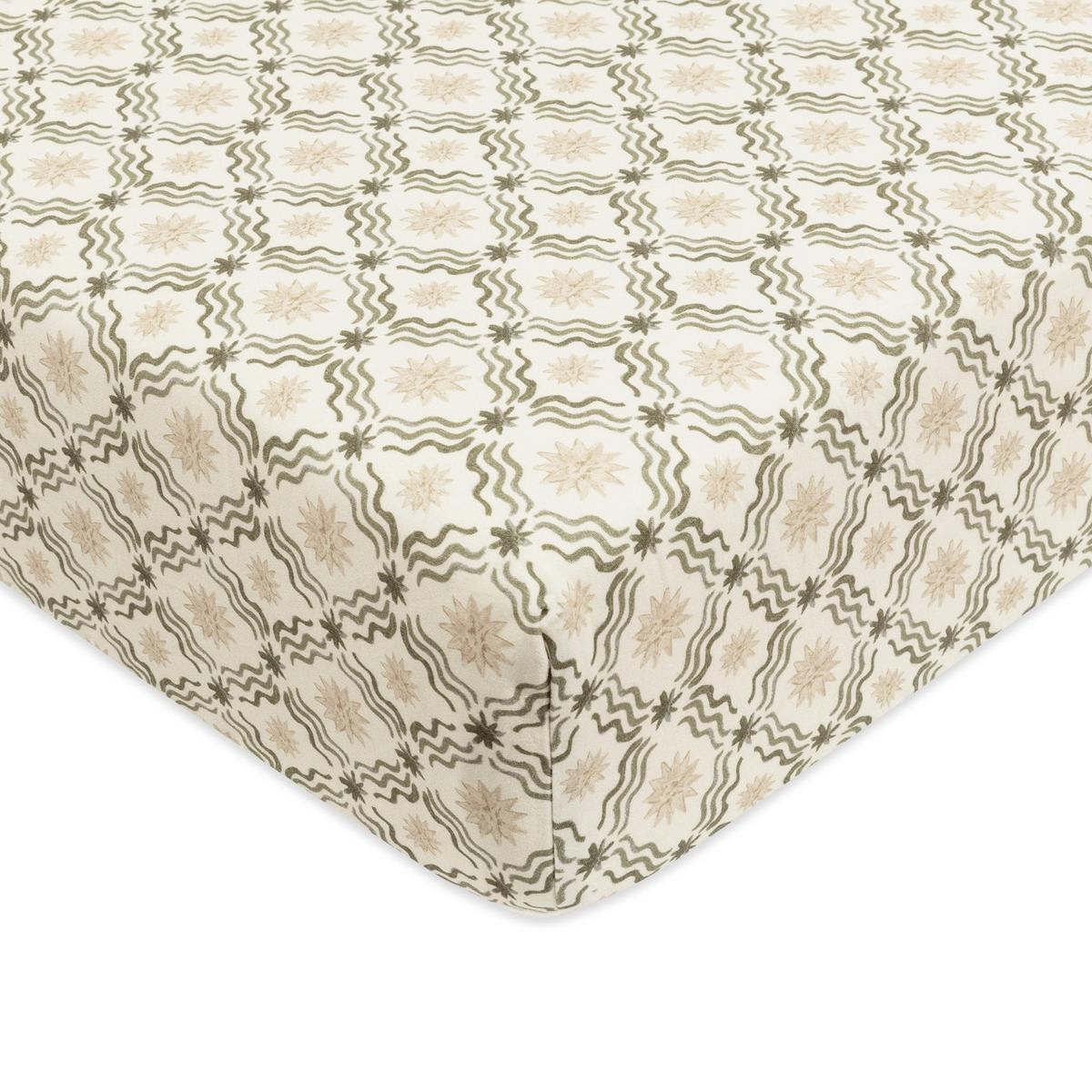 Babyletto crib sheet with cream background and olive green wavy line and star pattern