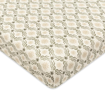 Babyletto crib sheet with cream background and repeating olive green wavy line and star pattern