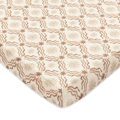 Babyletto crib sheet with tan wavy lines and star patterns on cream fabric