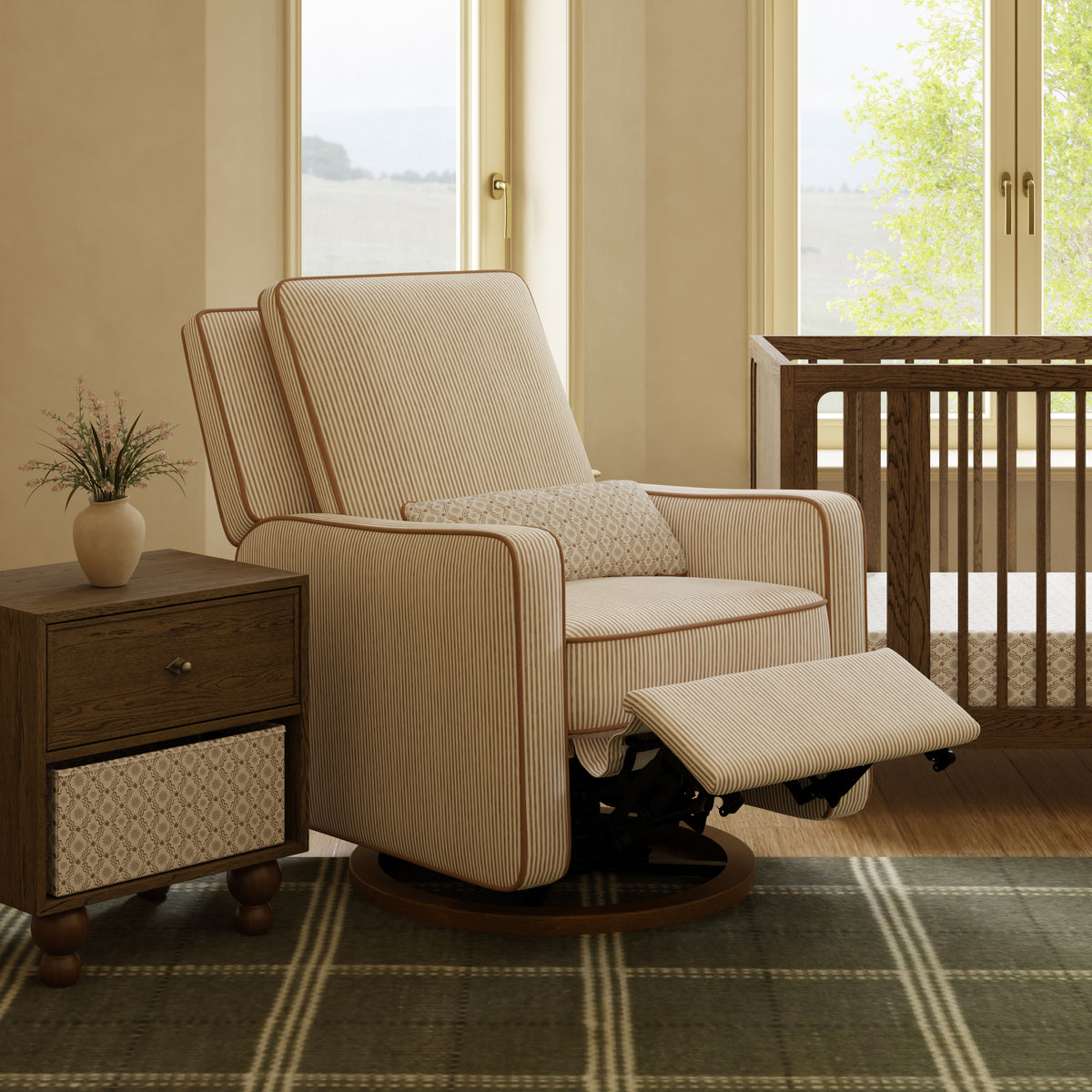 Babyletto striped swivel glider recliner with footrest extended in a nursery setting