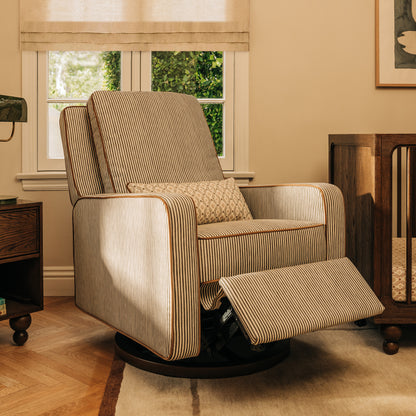 Babyletto striped swivel glider recliner with footrest extended in a nursery