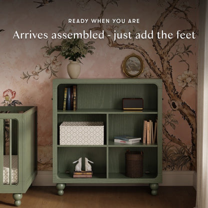 Babyletto green wooden bookshelf with open shelving and rounded corners