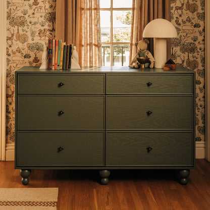 Babyletto six drawer dresser in dark green with wooden legs and small metal knobs