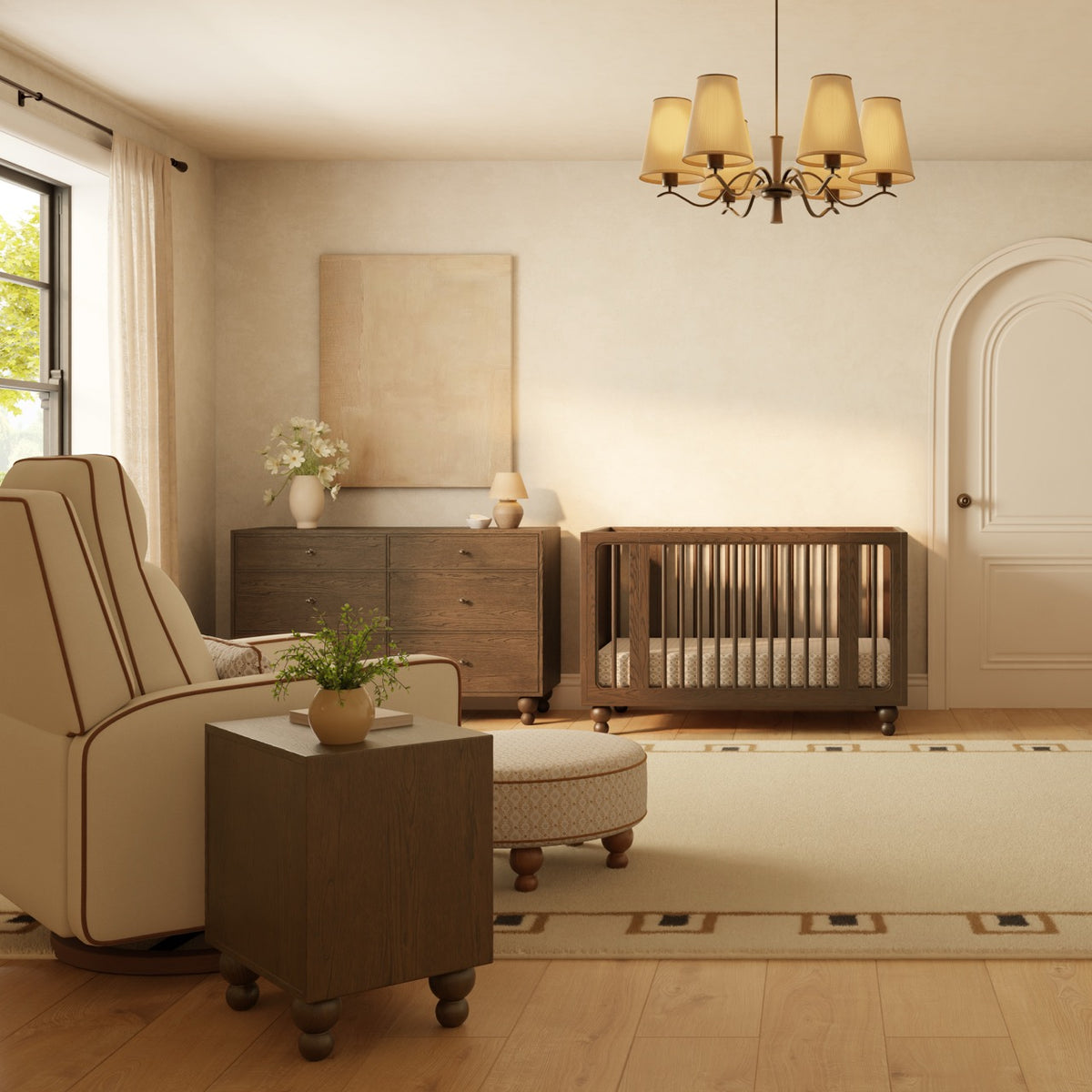 Babyletto nursery with dark wood crib dresser and side table alongside a cream armchair and ottoman