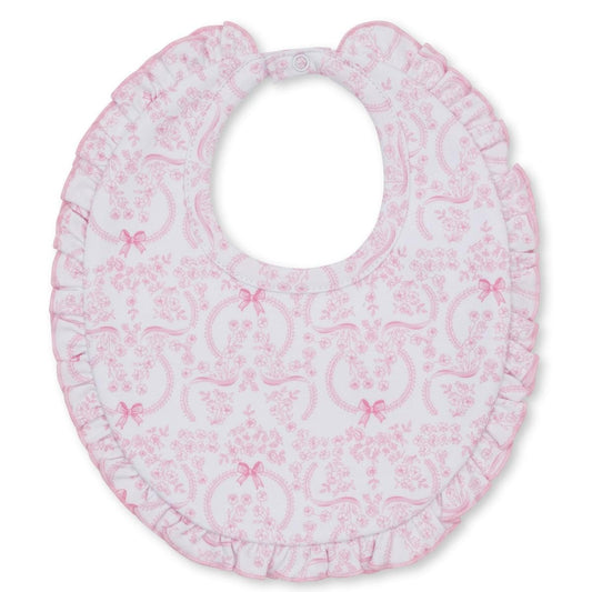 Kissy Kissy white baby bib with pink floral and bow print and ruffled trim