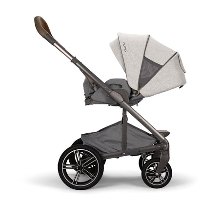 Nuna stroller in grey with a brown leather handle and storage basket