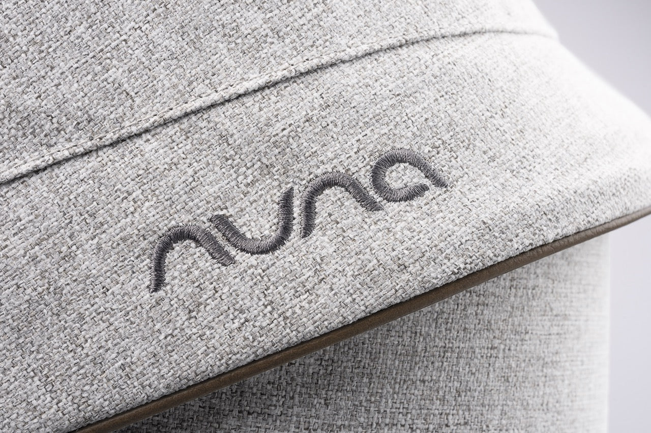 Nuna logo embroidered on light grey textured fabric