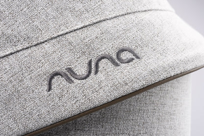 Nuna logo embroidered on light grey textured fabric