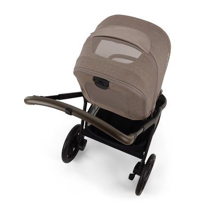 Nuna stroller with tan fabric seat and mesh ventilation window viewed from above